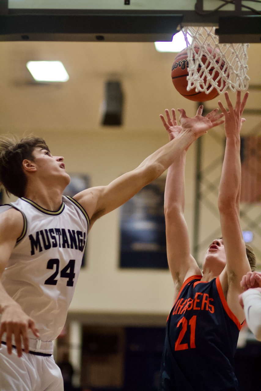 Isaac Gayler and Kelby Harwood battle for a rebound.
